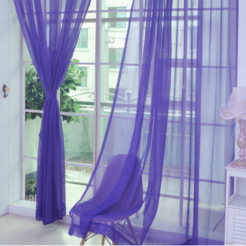 Shopi Vella purple transparent tulle window curtains hanging in a bright room with a chair