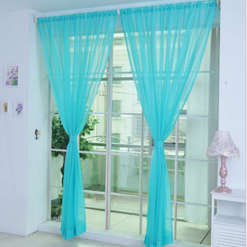Shopi Vella turquoise transparent tulle window curtains tied back on large glass sliding doors