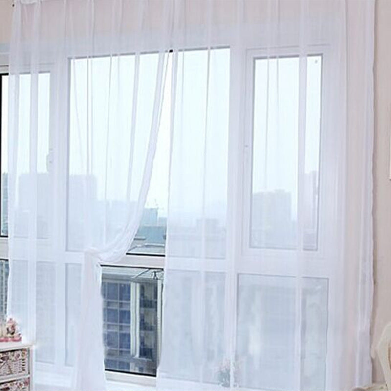 Shopi Vella transparent tulle window curtains hanging in a bright room with large windows