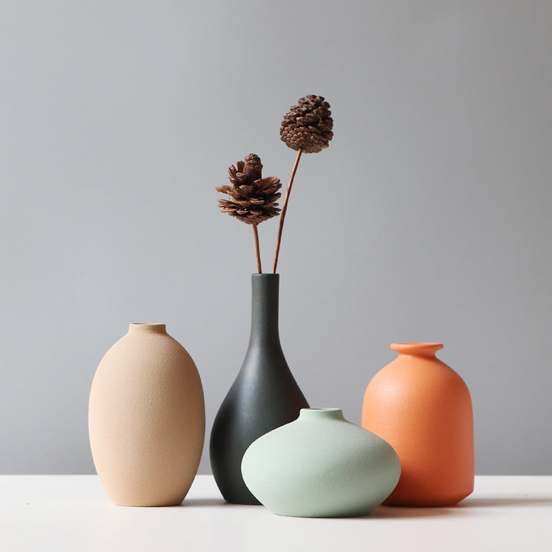 Minimalist TV cabinet flower stand with four decorative vases in neutral and pastel colors