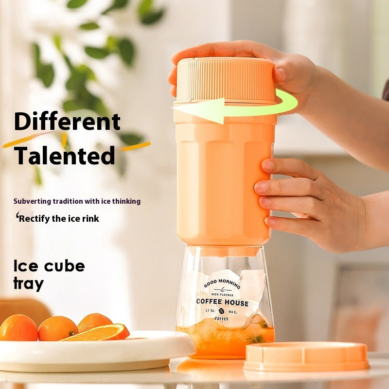 Shopi Vella twisting ice cup mold for freezer in orange being held and twisted over a glass with ice cubes inside