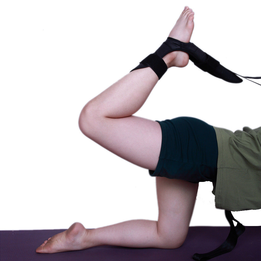 Person using leg stretching strap for physical therapy to stretch and improve flexibility on a yoga mat