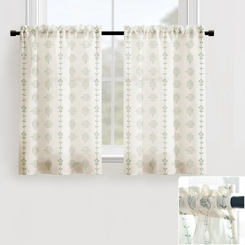Cream and green patterned under sink cabinet curtains hanging on a black rod in front of a window