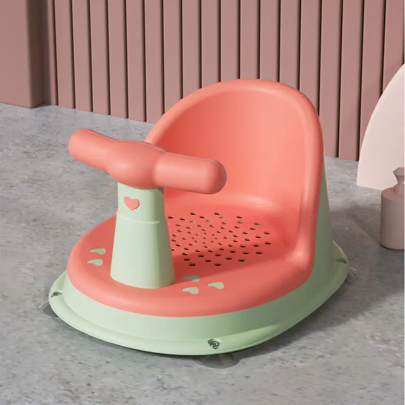 Pink and green universal baby bath seat with handle and drain holes for safe infant bathing