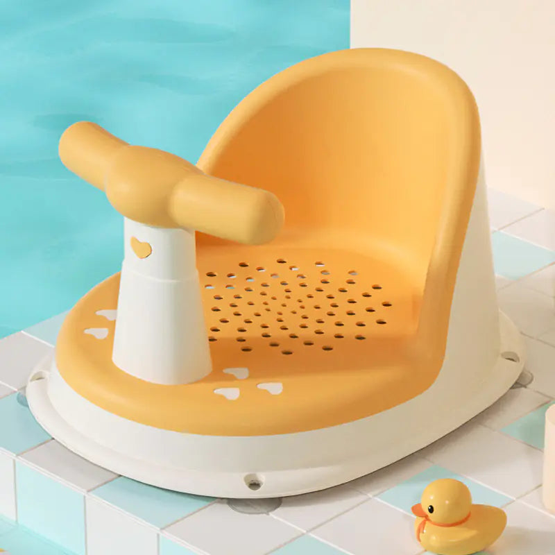 Yellow and white universal baby bath seat with safety handle and drainage holes next to rubber duck