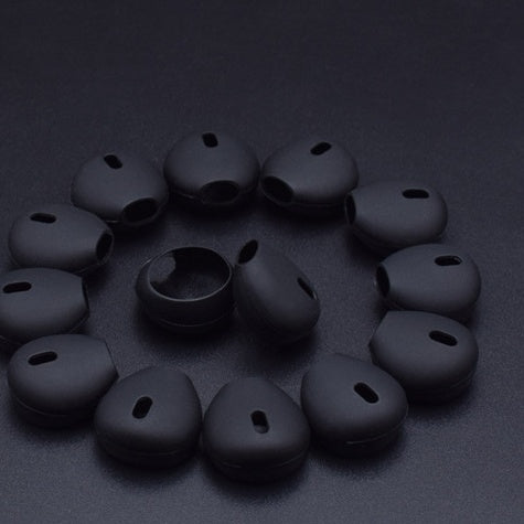 Shopi Vella black headphone silicone case in multiple pieces arranged in a circle on a black background