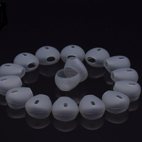 Transparent gray headphone silicone case for protecting earbuds organized in a circle on black background