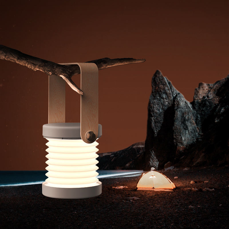 USB rechargeable lantern for home decor hanging from a branch illuminating outdoor night scene
