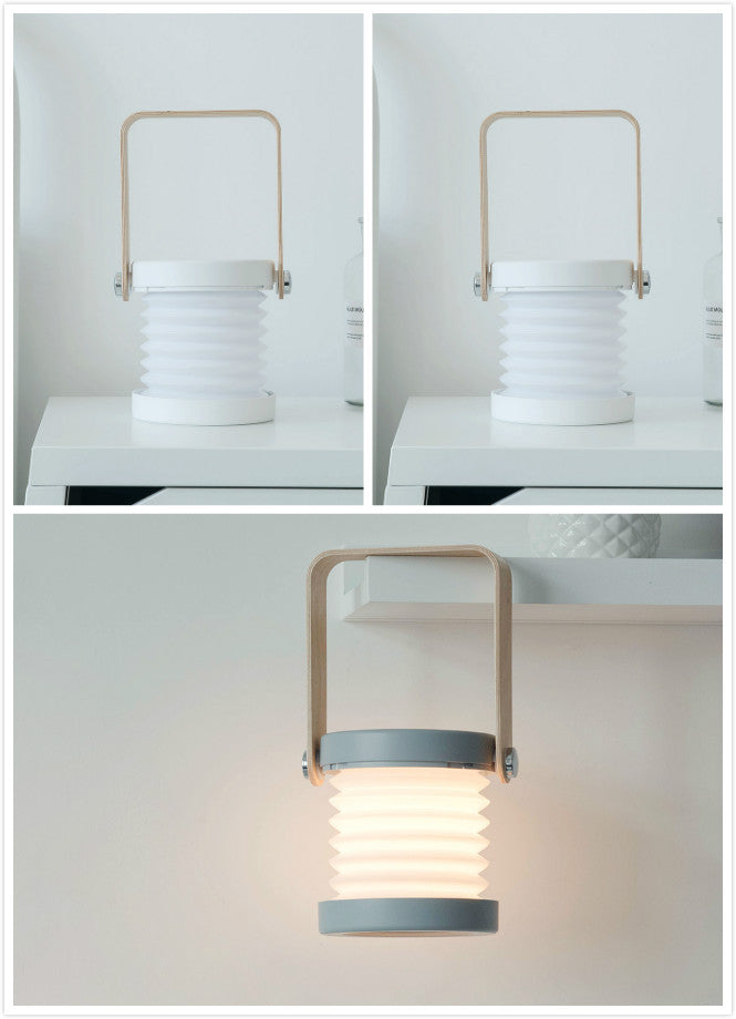 USB rechargeable lantern for home decor with collapsible white body and wooden handle shown on table and hanging