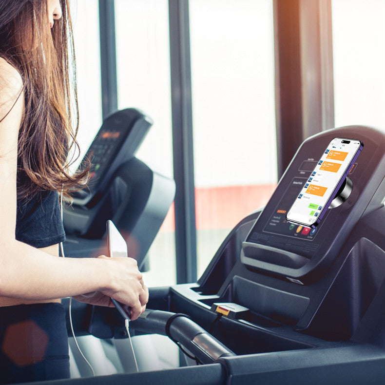 Vacuum adsorption phone holder attached to treadmill with phone displaying fitness app