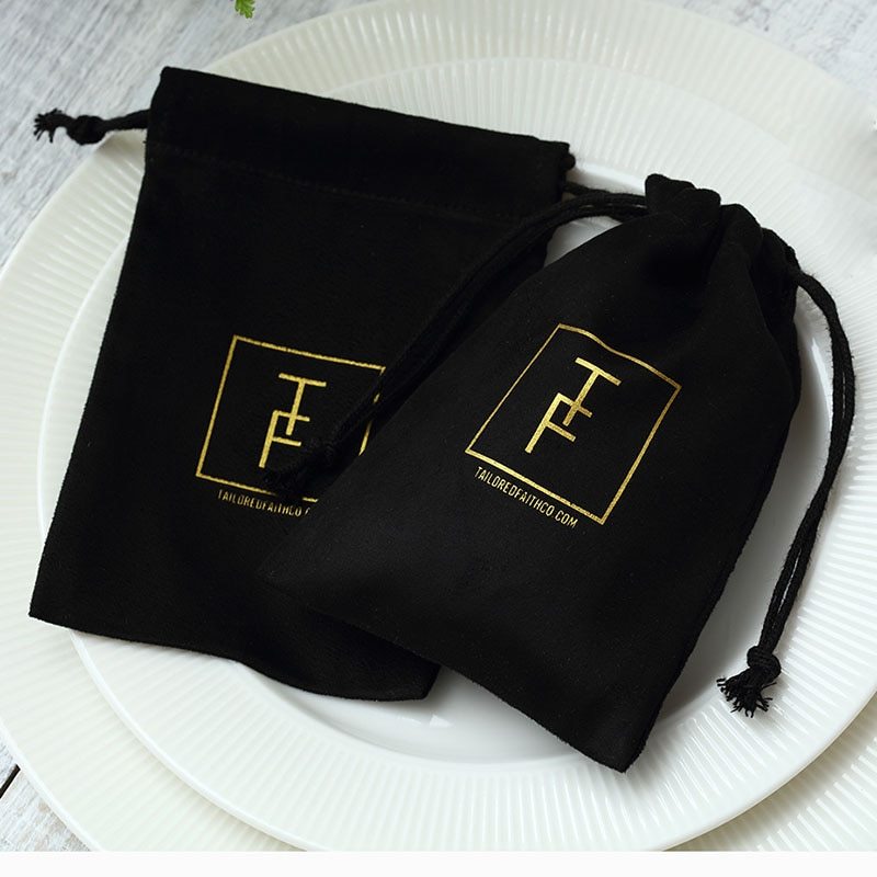 Black velvet jewelry gift bag with gold logo and drawstring closure for stylish home storage