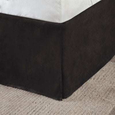 Close-up of black bed skirt in Shopi Vella 7 piece faux suede comforter set on carpeted floor