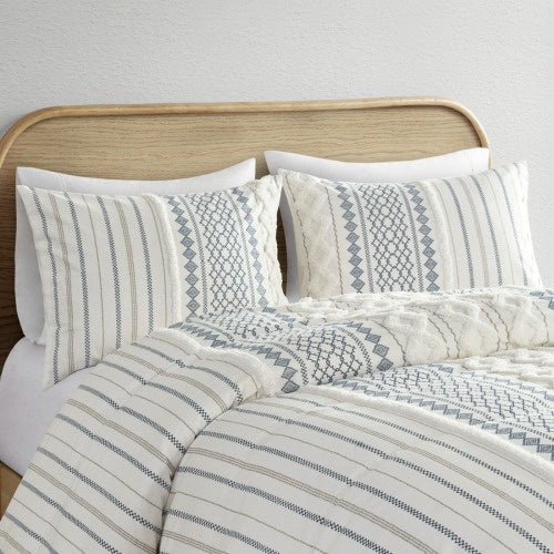 Shopi Vella cal king chenille duvet set with textured patterns and matching pillow shams on wooden bed