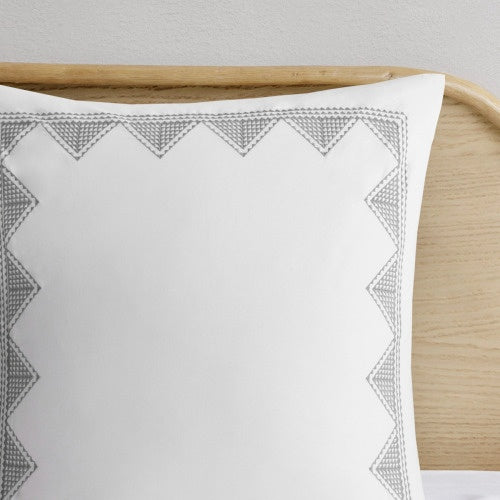 Shopi Vella cal king chenille duvet set white pillow with gray geometric stitching on wooden headboard