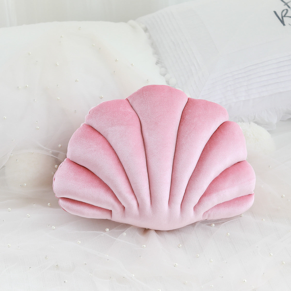 Shopi Vella cute shell nap pillow for kids in soft pink velvet pillow case on white bedding