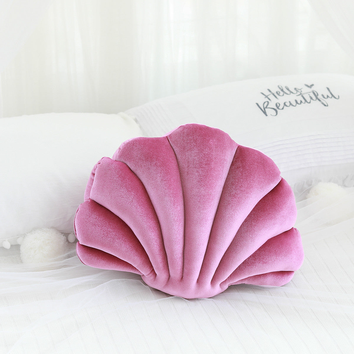 Shopi Vella cute shell nap pillow for kids in soft pink velvet fabric on white bedding