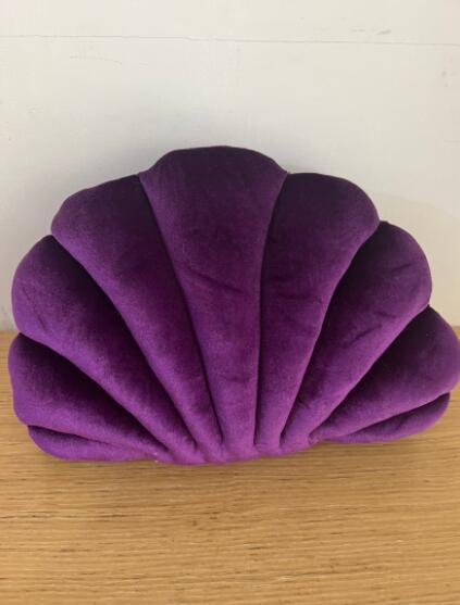 Shopi Vella purple cute shell nap pillow for kids with soft plush fabric on wooden surface