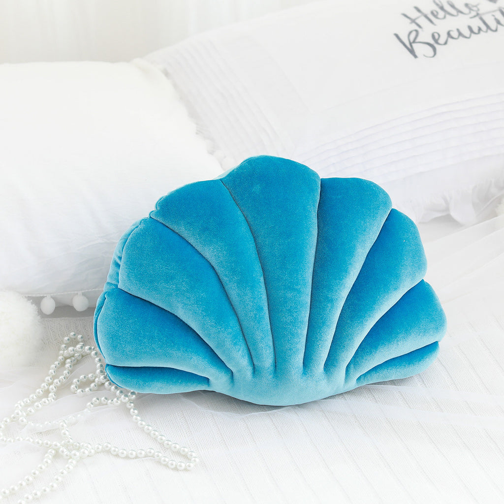 Shopi Vella cute shell nap pillow for kids in soft blue velvet on white bed linens