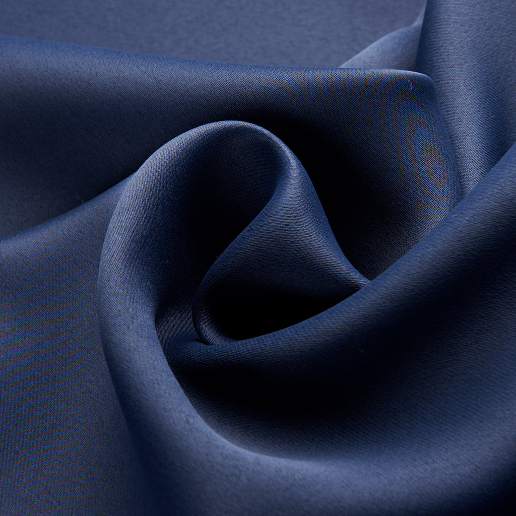 Close-up of smooth dark blue blackout curtains fabric with elegant texture and deep color
