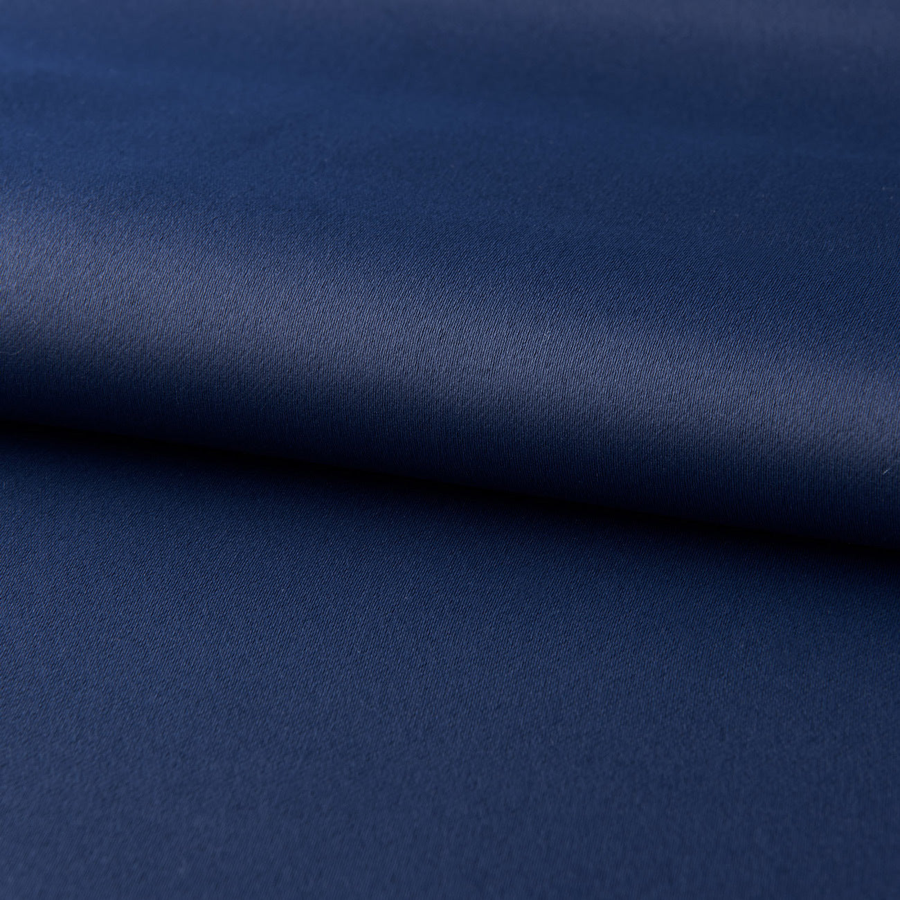 Close-up of dark blue blackout curtains fabric texture from Shopi Vella for light-blocking comfort