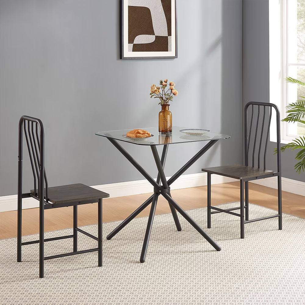 Shopi Vella glass dining set for 2 with a round glass table and two black metal chairs in modern dining room