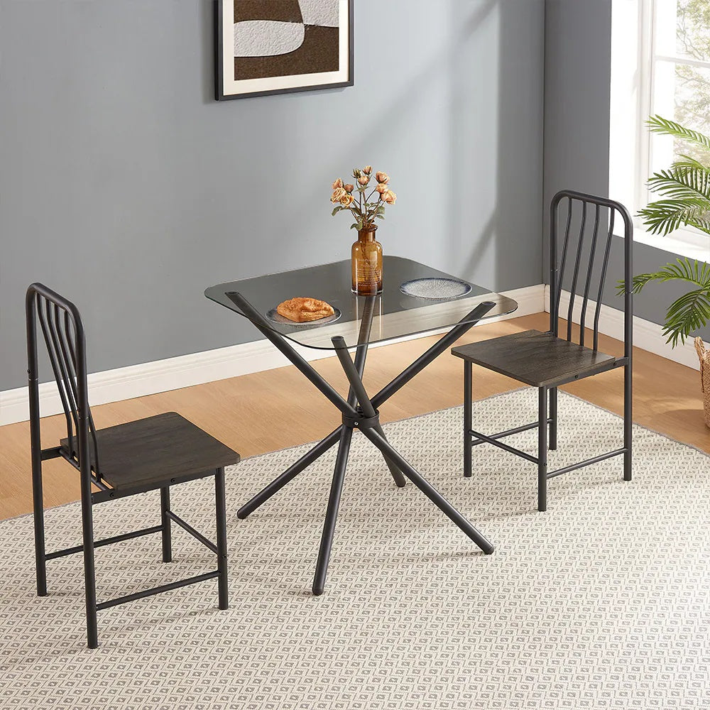 Shopi Vella glass dining set for 2 with black metal frame and dark wood chairs on patterned rug