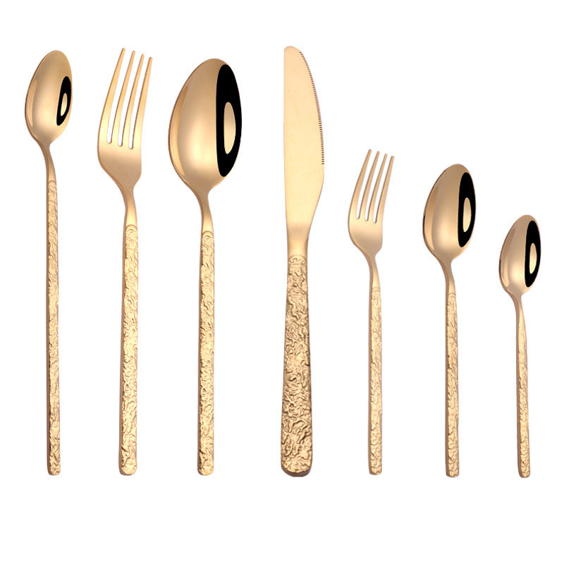 Shopi Vella gold cutlery set for dinner parties featuring textured handles with spoons forks and knives