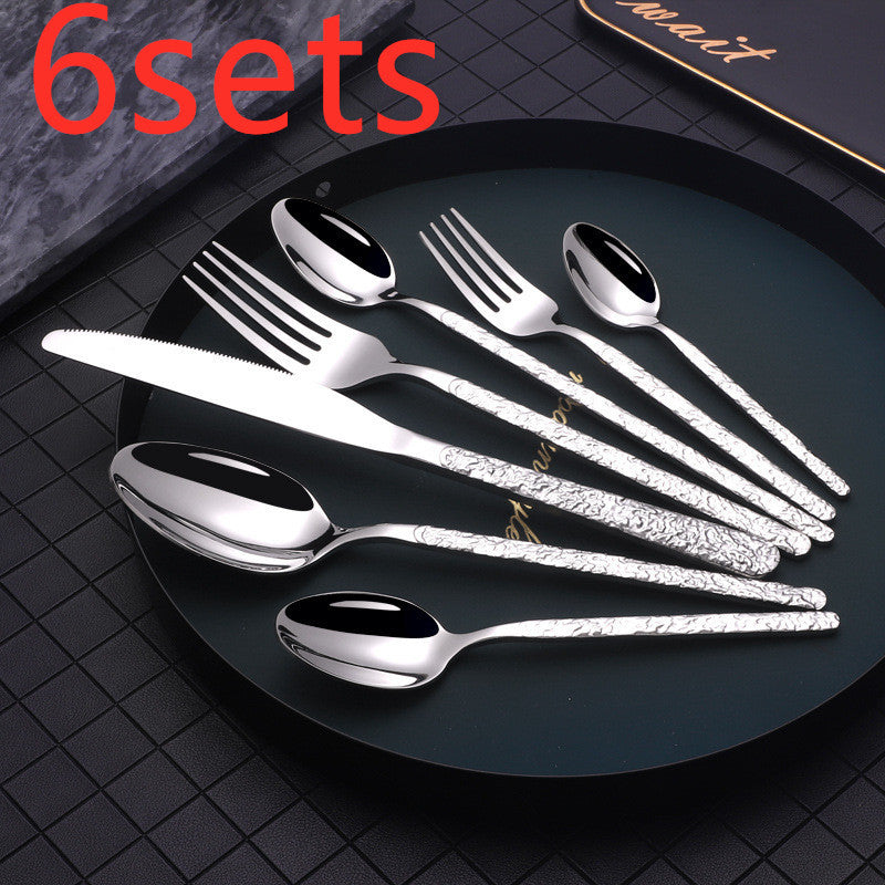 Elegant silver cutlery set displayed on black plate suitable for dinner parties and special occasions