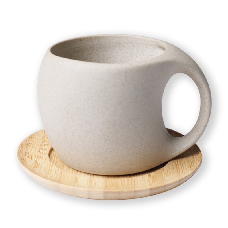 Handcrafted pottery pitcher set featuring a light beige ceramic pitcher with round handle and wooden saucer
