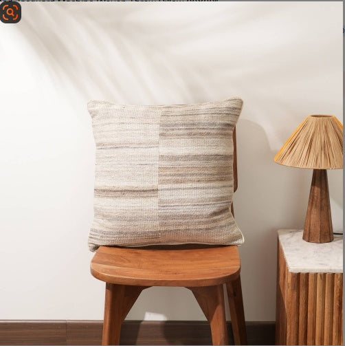 Shopi Vella jacquard throw pillow 20x20 in neutral tones on wooden chair with lamp