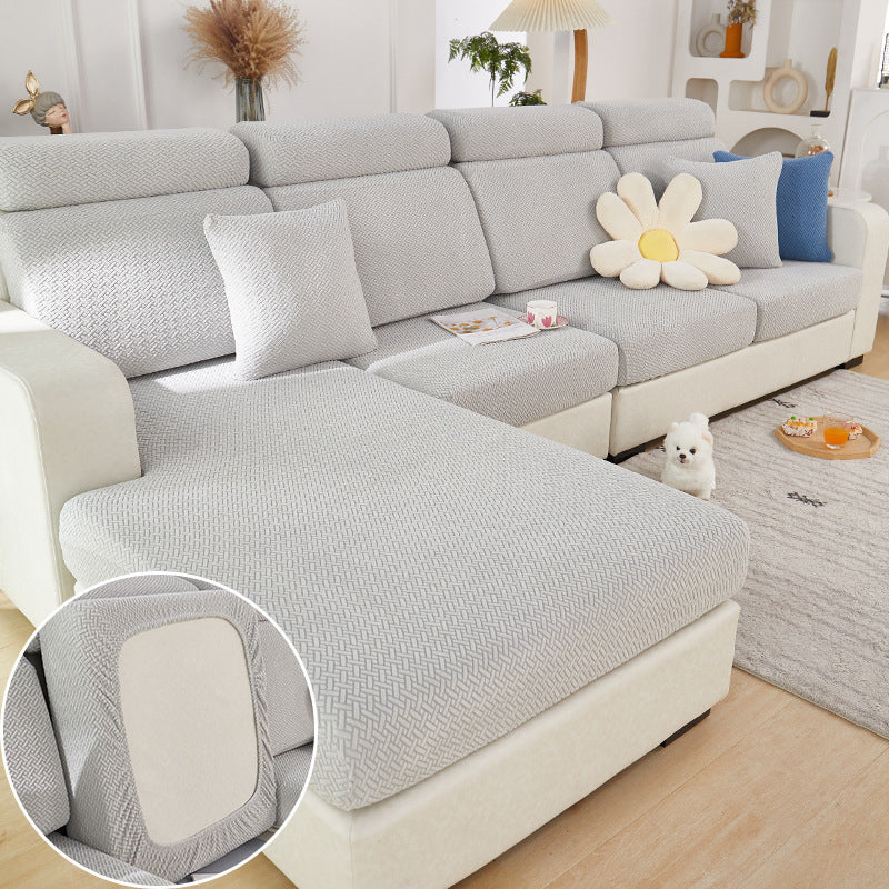 Shopi Vella machine washable sofa cushion cover in light gray with textured pattern on sectional sofa