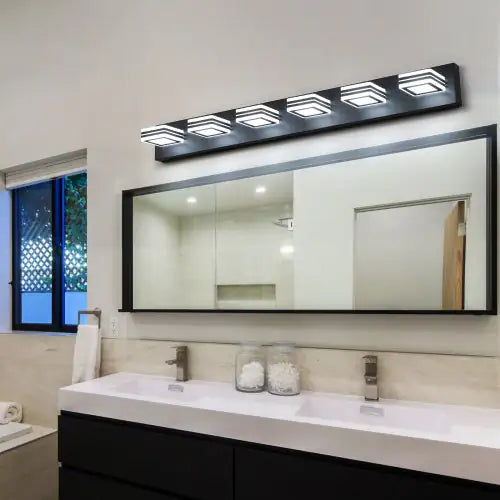 Modern black bathroom vanity light with five square LED fixtures mounted above a large mirror