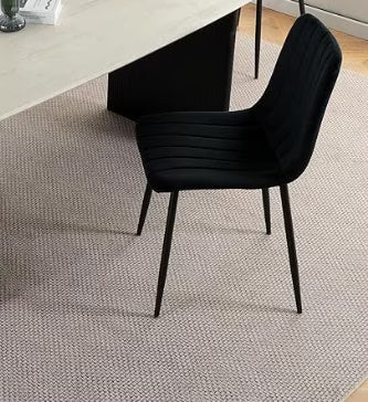 Black modern kitchen chair set with slim metal legs featured in a contemporary dining room