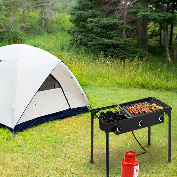Shopi Vella multi burner kitchen gas stove with grill cooking vegetables and sausages outdoors