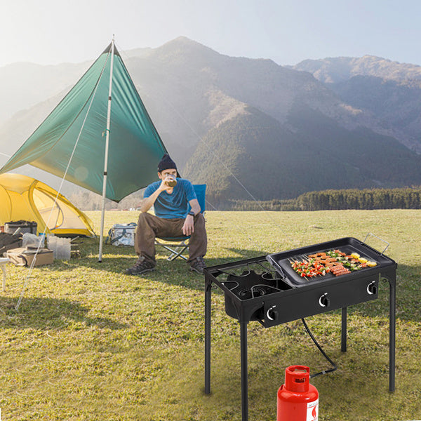 Shopi Vella multi burner kitchen gas stove with grill cooking vegetables and meat outdoors near camping tent