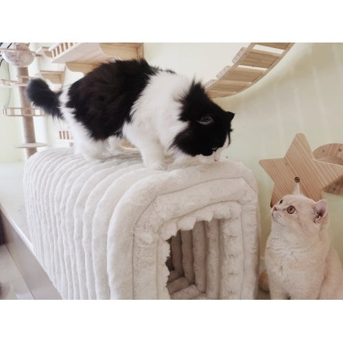 Ottoman storage bench with pet hideaway featuring soft plush material with black and white cat on top and cream cat nearby
