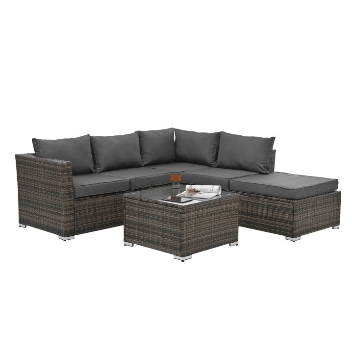 Outdoor wicker patio furniture set with dark gray cushions and glass top coffee table