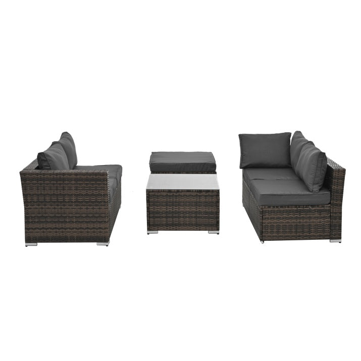 Modern outdoor wicker patio furniture set with dark cushions and glass-top coffee table