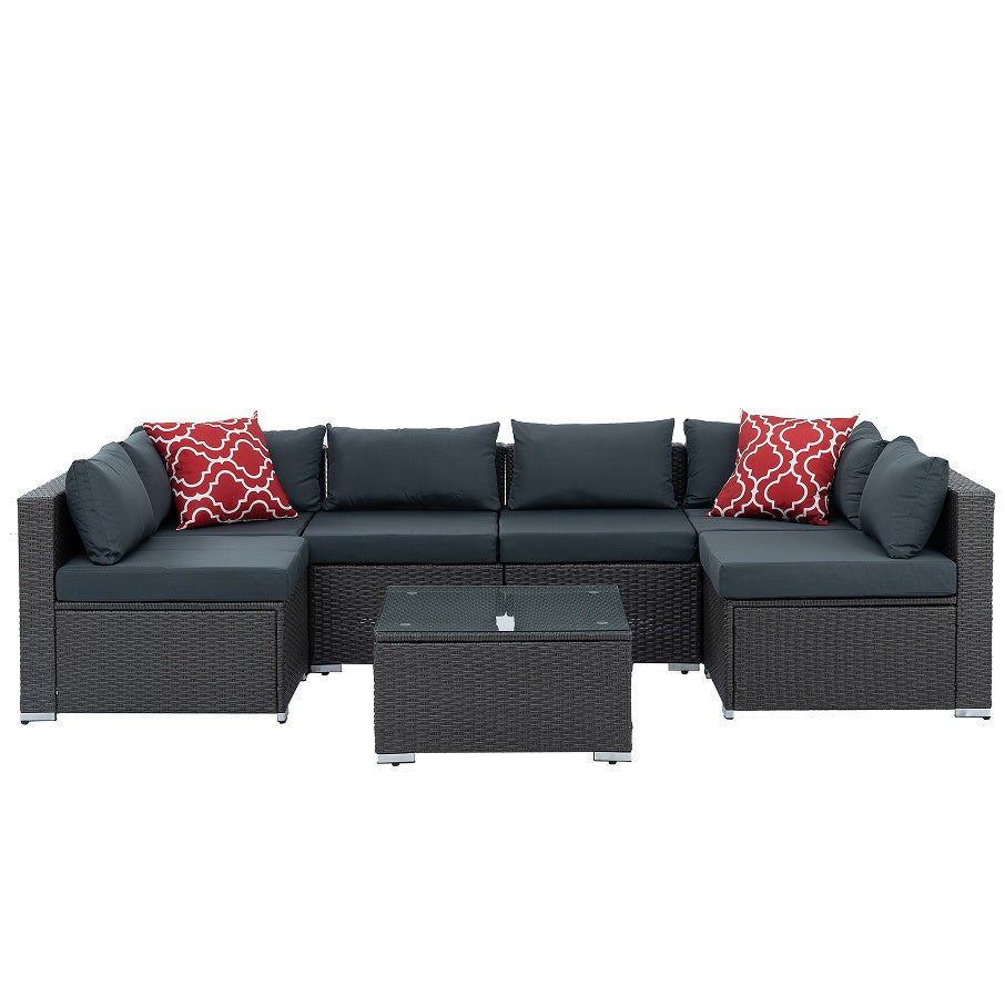 PE wicker patio furniture with coffee table and black cushions with red patterned pillows