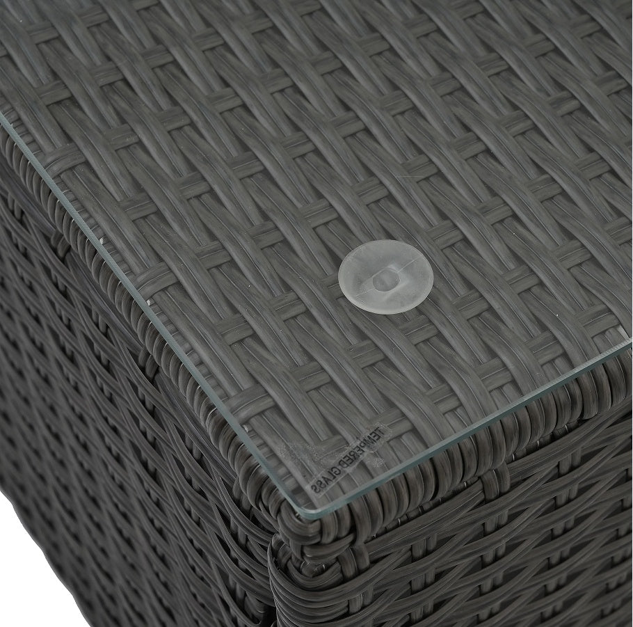 Close-up of gray PE wicker patio furniture with coffee table featuring woven texture and glass top