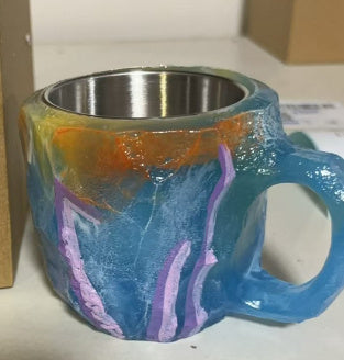 Shopi Vella resin crystal coffee mug with colorful blue and orange resin exterior and stainless steel interior
