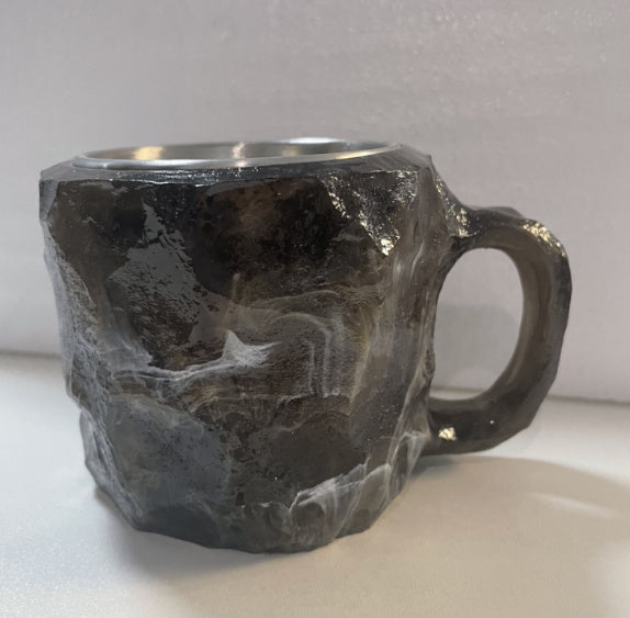 Shopi Vella resin crystal coffee mug with a rugged black stone-like textured surface and handle