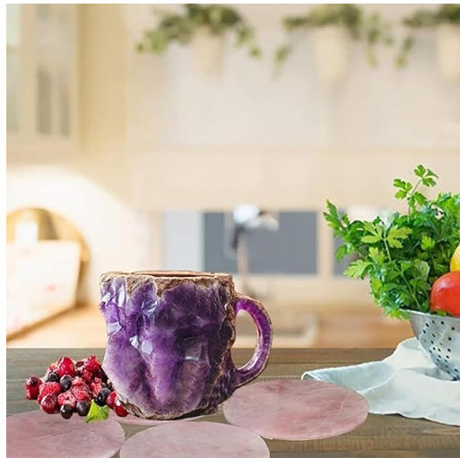 Purple resin crystal coffee mug on wooden table with fresh berries and kitchen decor background