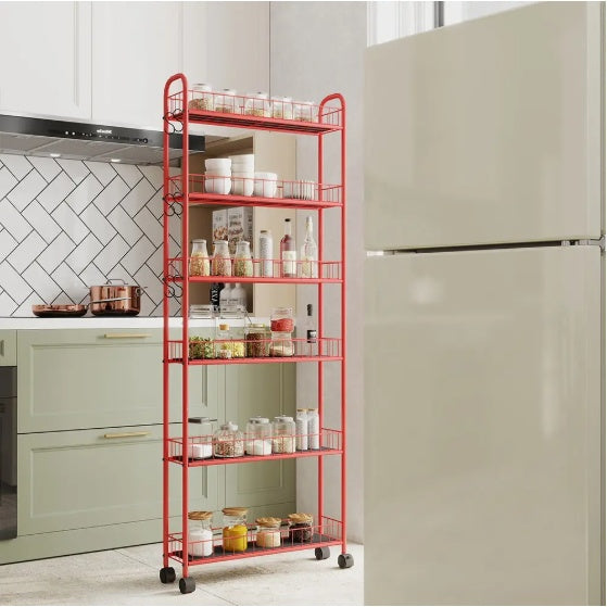 Shopi Vella slim rolling kitchen storage cart in red with five wire shelves holding jars and bottles beside refrigerator