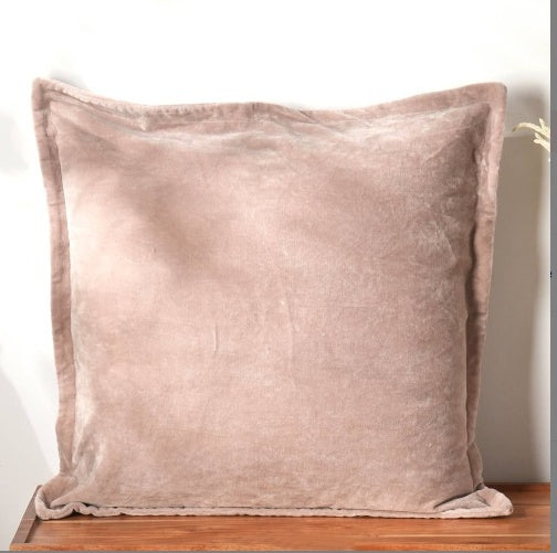 Shopi Vella solid throw pillow with flange in soft dusty pink velvet fabric on wooden surface