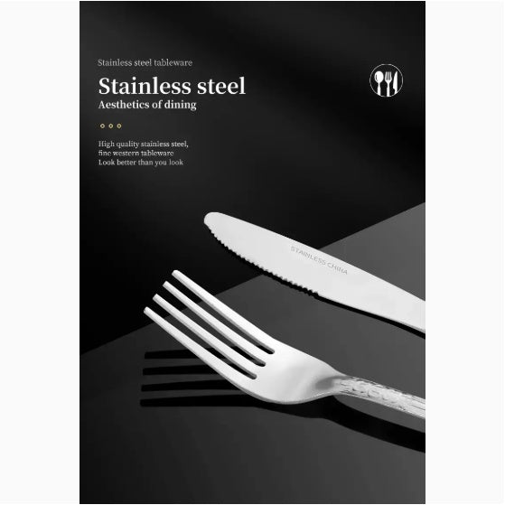 Shopi Vella stainless steel cutlery set featuring a fork and serrated knife on a black surface