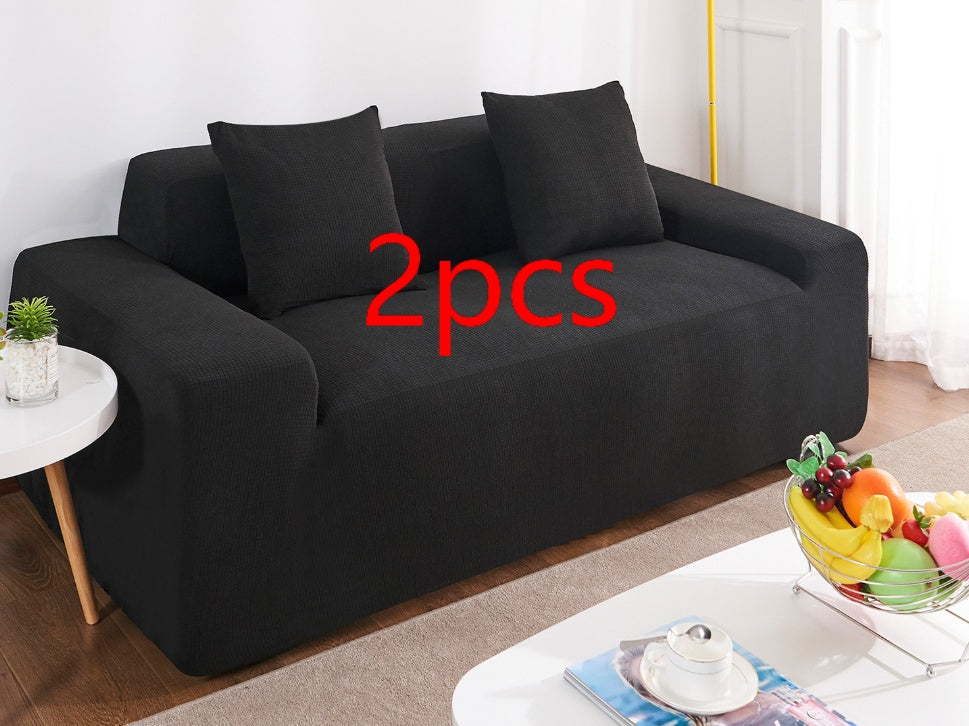 Shopi Vella black waterproof sofa slipcover on two-seat sofa with matching cushions in living room