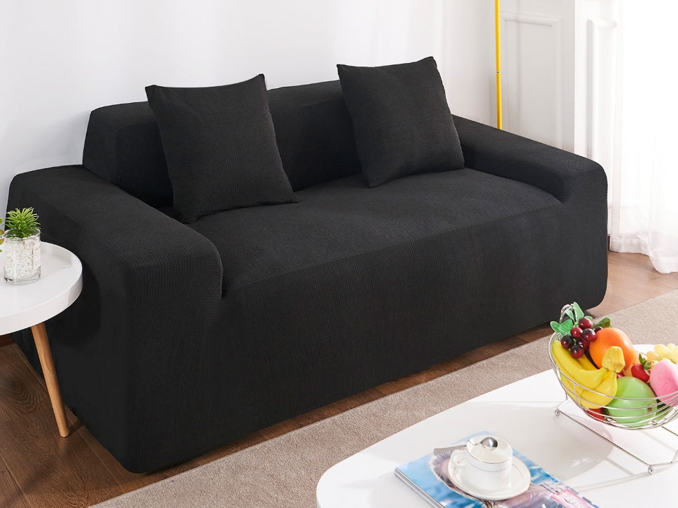 Shopi Vella black waterproof sofa slipcover fitted on modern two-seater sofa with cushions