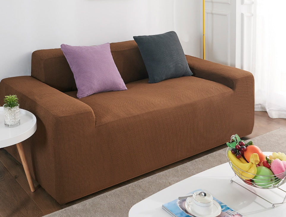 Shopi Vella brown waterproof sofa slipcover on modern sofa with purple and black pillows in living room