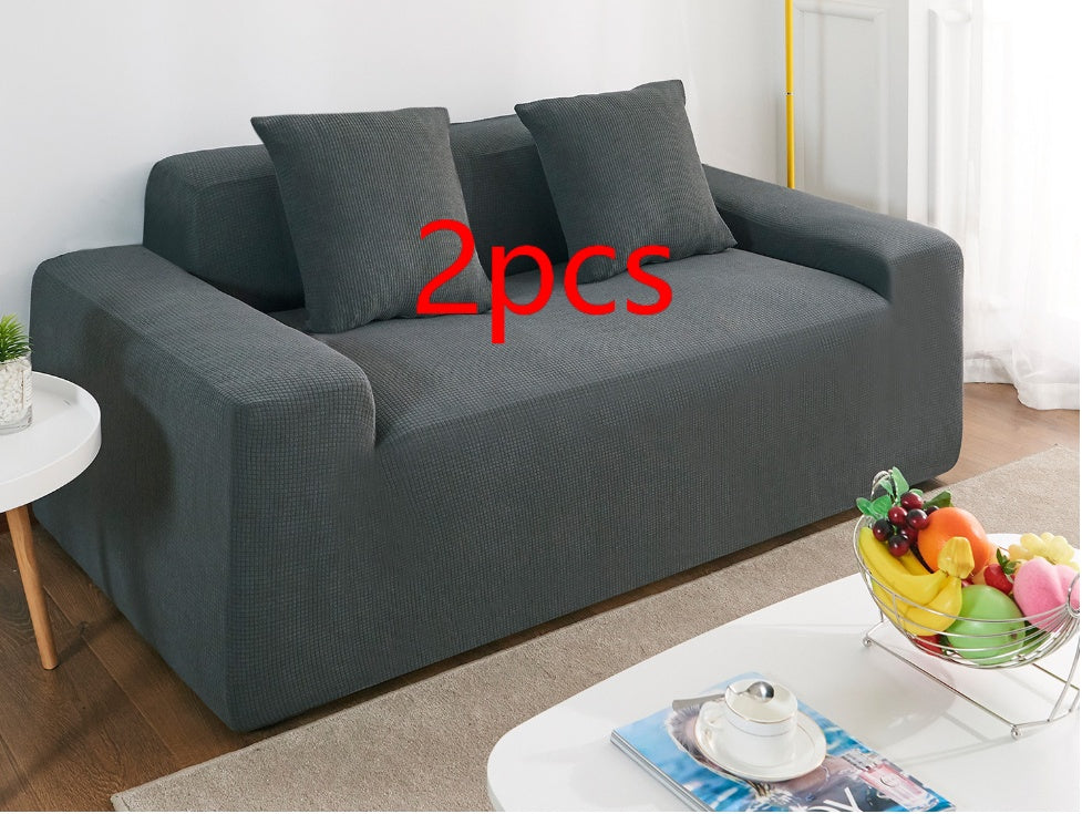 Shopi Vella waterproof sofa slipcover in dark gray fitted on a three-seater sofa with matching cushions